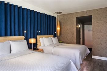 A stylish view of the Arthouse Hotel NYC lobby showcasing its artistic decor and cozy seating areas.