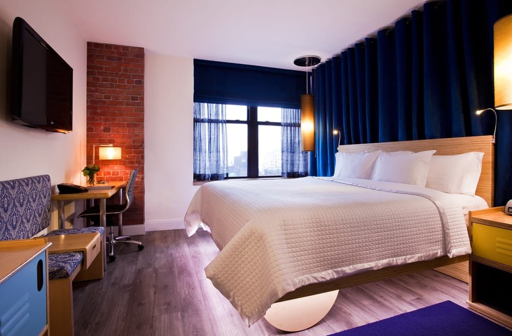 A stylish view of the Arthouse Hotel NYC lobby showcasing its artistic decor and cozy seating areas.